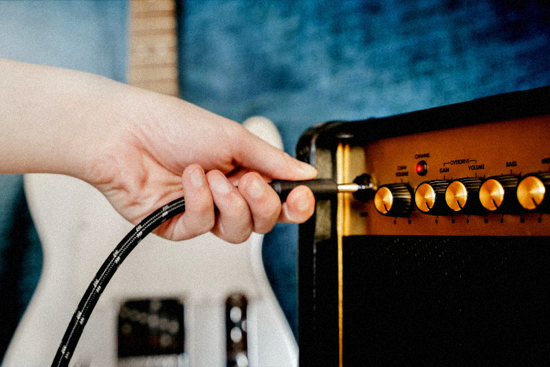 Person plugging in card into amplifier